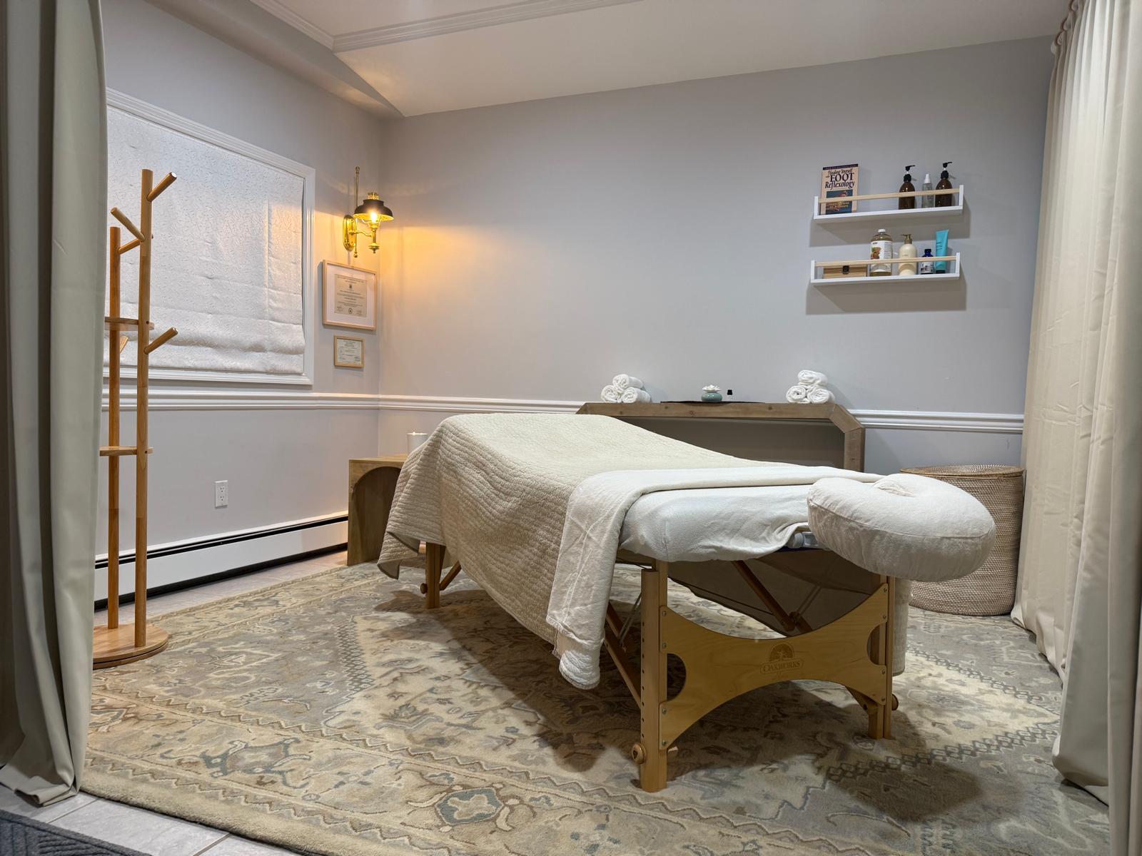 Massage therapy room with professional table and warm lighting